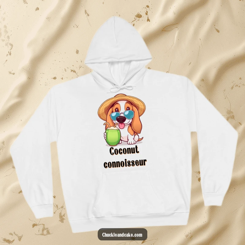 Funny Basset Hound hoodie showing a Basset Hound wearing a sun hat and sipping a coconut drink, perfect for cozying up.