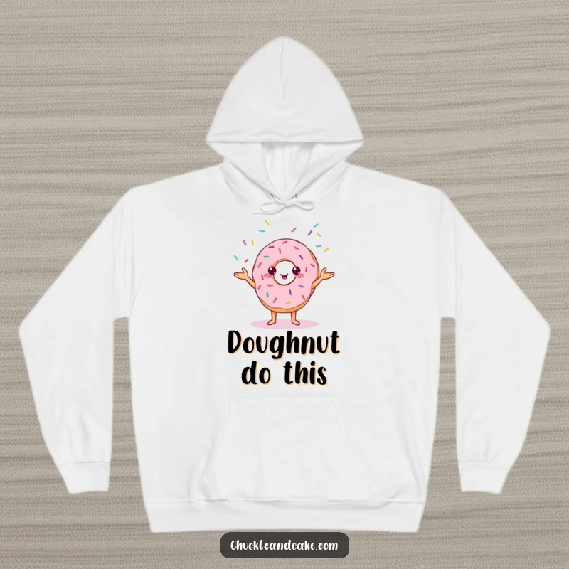 Funny hoodie showcasing a cheerful donut with small eyes, performing a juggling act with colorful sprinkles.