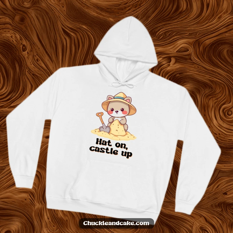 Funny hoodie depicting an animal in a sun hat, diligently constructing a sandcastle with a shovel.