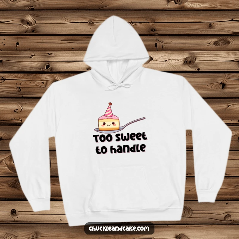 Funny hoodie showcasing a smiling cake slice with a party hat precariously balanced on a spoon, embodying cheerful mischief and warmth.