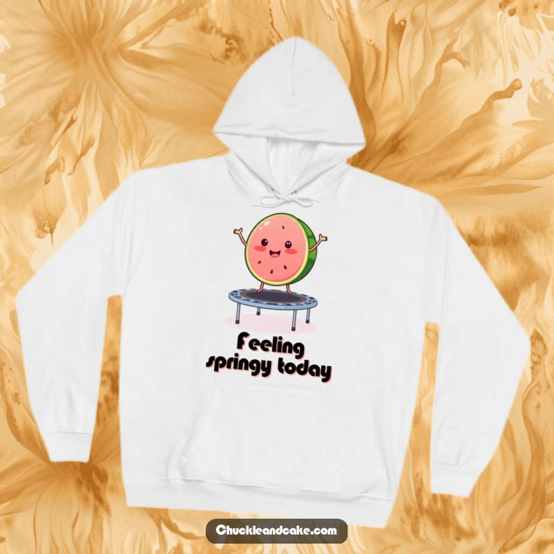 Funny watermelon hoodie showing a merry slice of watermelon joyfully bouncing on a trampoline, offering warmth and summer cheer.