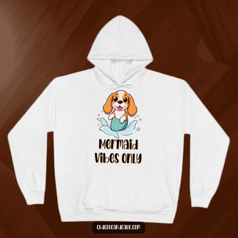 Funny Basset Hound wearing a mermaid tail, splashing in gentle waves, creating a magical scene on a hoodie.