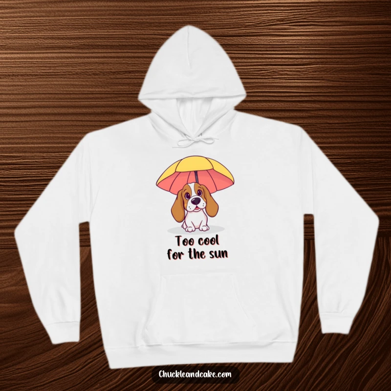 Funny Basset Hound Hoodie: A Basset Hound peeking from behind a beach umbrella, embodying relaxed beach vibes and cozy humor.