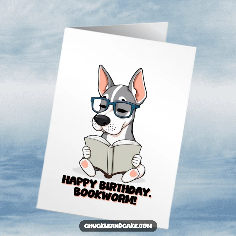 Funny Free Printable Birthday Card: A Grand Dane wearing tiny glasses intently reads a large book, looking very studious.