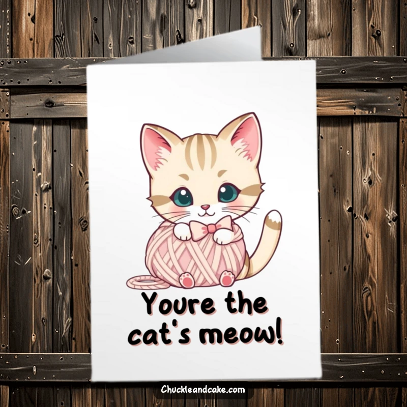 Free Printable Congratulations Card: A Bobtail cat in a bow peeks playfully from behind a yarn ball.