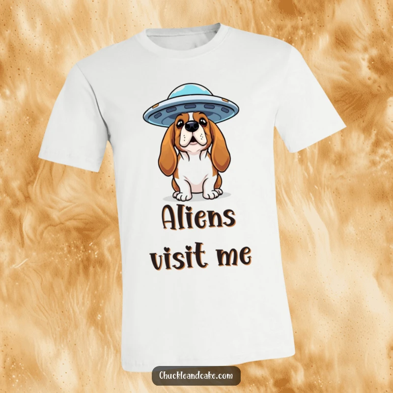 Funny Basset Hound t-shirt showing a curious dog looking up at a flying saucer, hinting at an alien encounter.