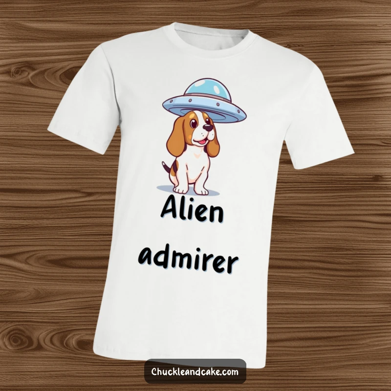 Funny Basset Hound T-Shirt featuring a dog looking curiously at a hovering flying saucer, a humorous take on alien encounters.
