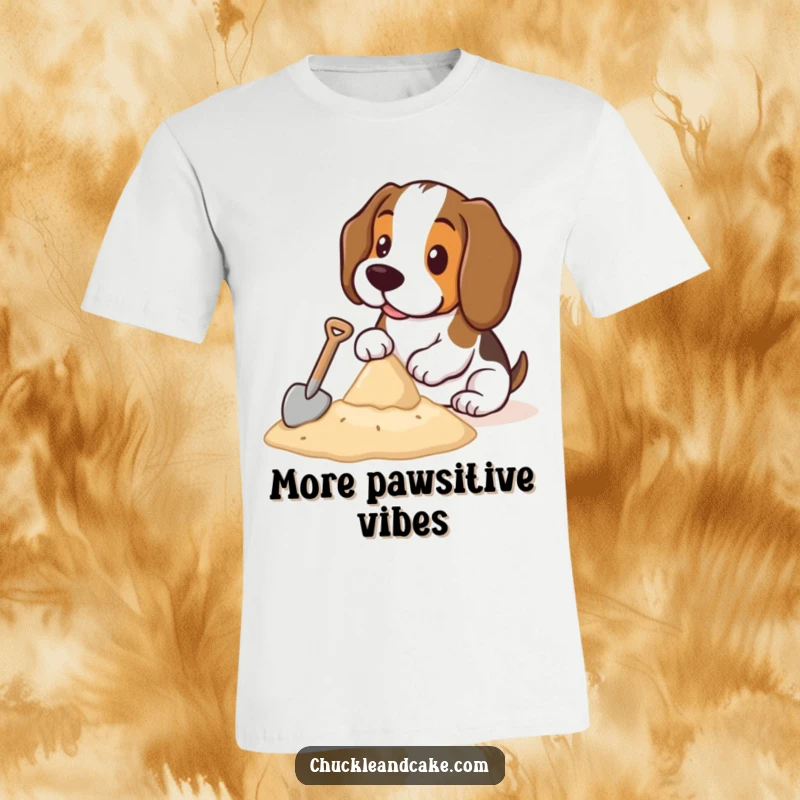 Funny Basset Hound T-shirt showing a cute Basset Hound focused on building a sandcastle with a miniature shovel on a sandy beach.