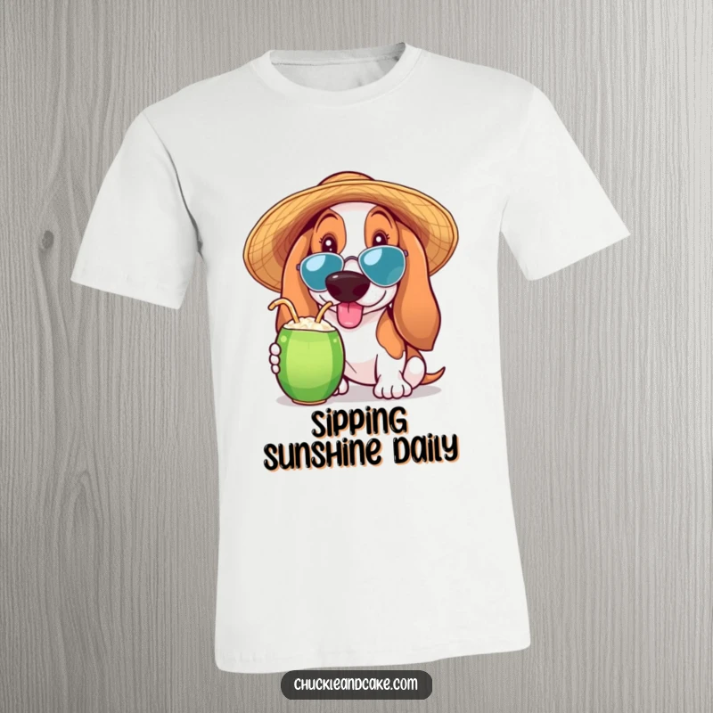Funny Basset Hound T-shirt of a Basset Hound in a sun hat sipping a coconut drink, capturing a moment of pure tropical enjoyment.