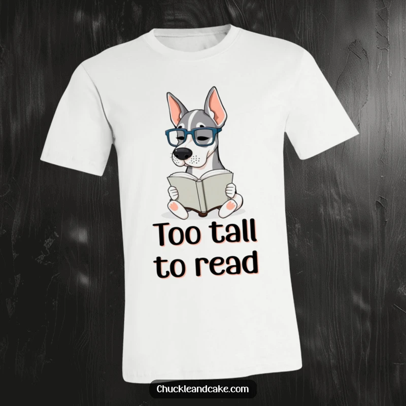 Funny Grand Dane Glasses T-Shirt: A Grand Dane wearing tiny glasses is engrossed in reading a book, exuding intelligence.